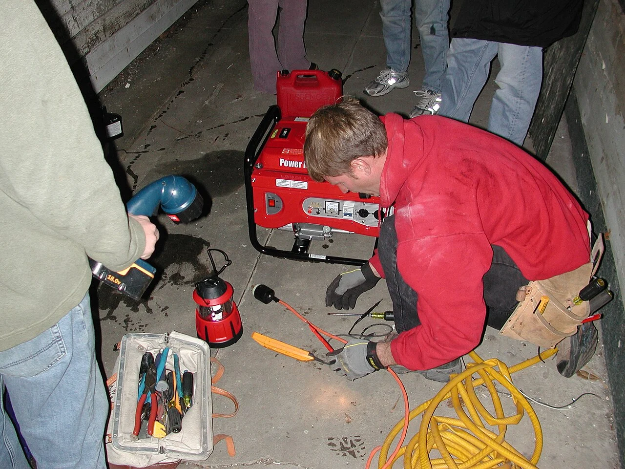 An electrician connecting a generator to a home electrical panel