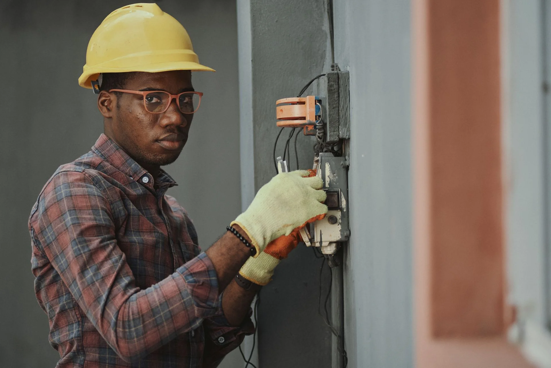 An electrician beside a wall switch during installation work